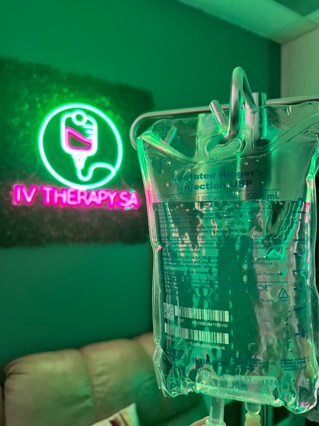 IV Therapy SA neon sign in the clinic beside an IV bag